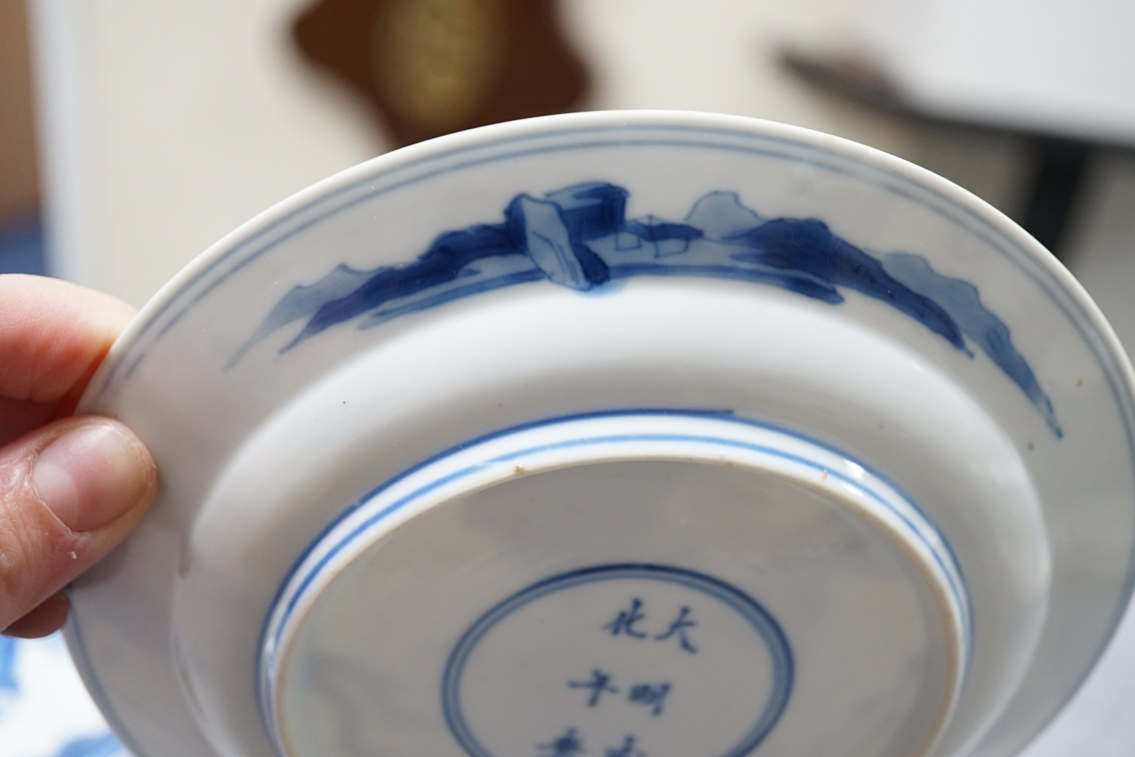 A pair of Chinese blue and white small plates, Kangxi period, hairline cracks to one plate.